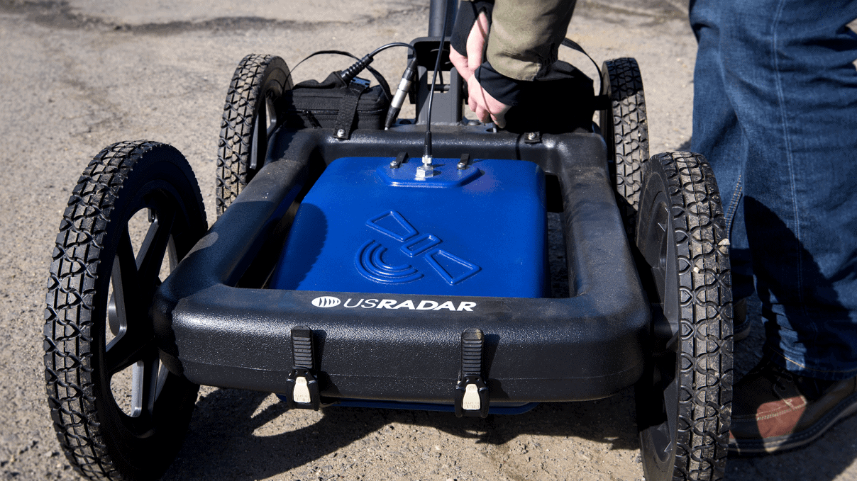 a person pushes ground penetrating radar equipment