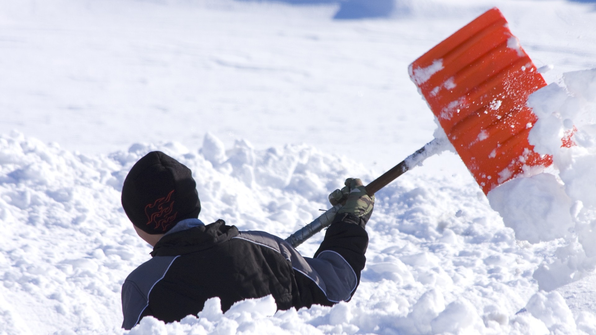a person digs through deep snow