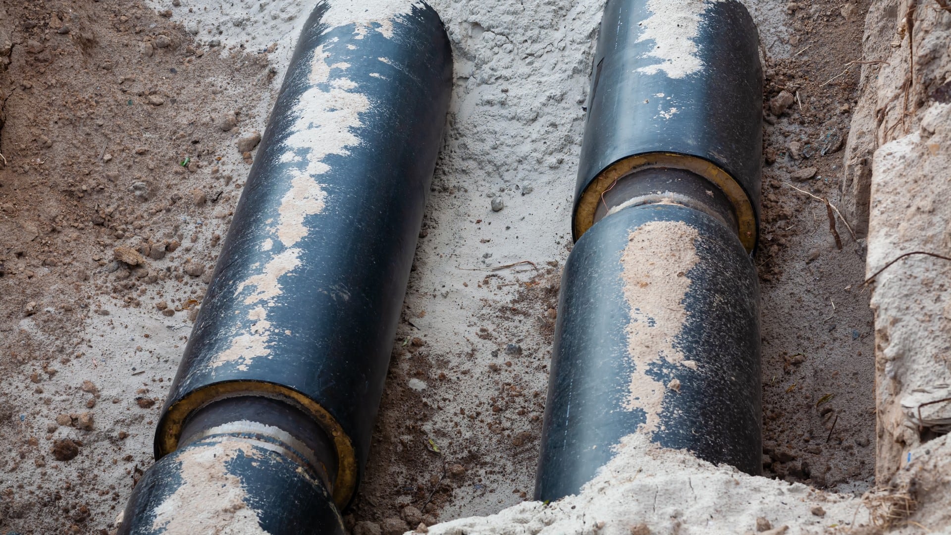 two underground pipes are covered in dirt