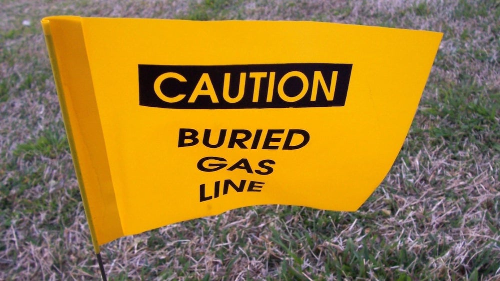 A sign labeled, "CAUTION: BURIED GAS LINE