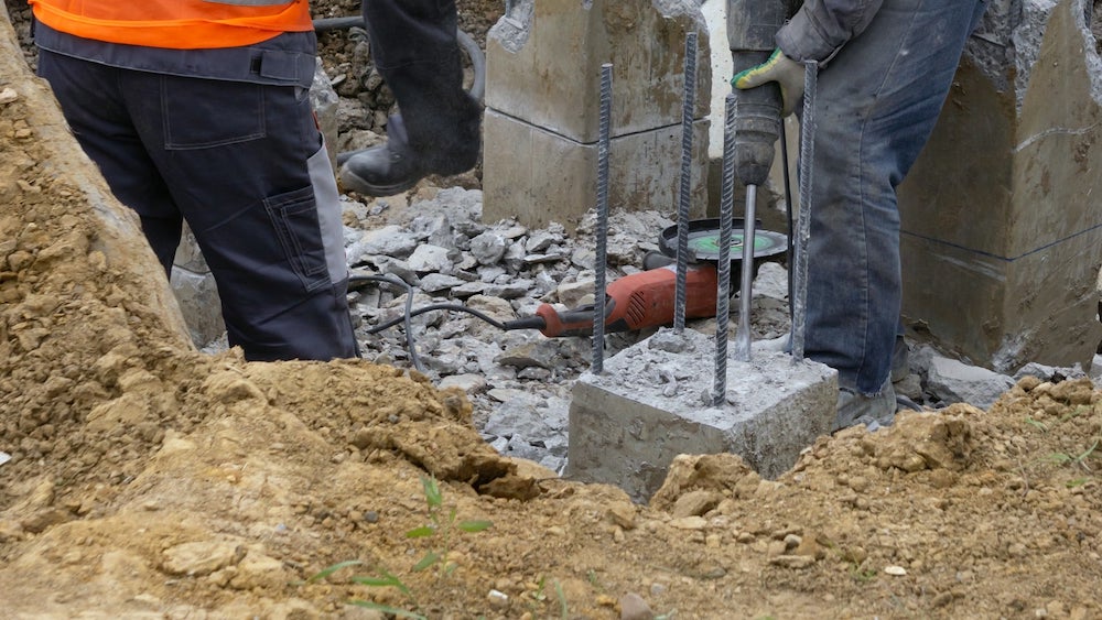 workers at construction site chop with a jackhammer